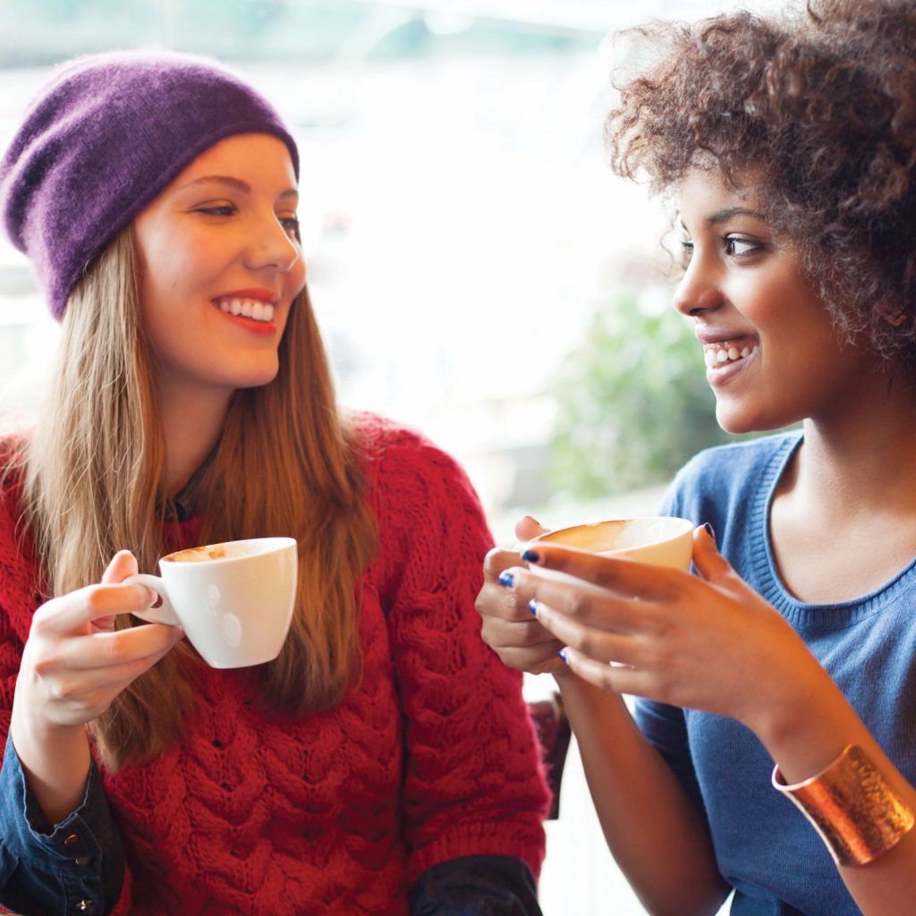 young women-conversation-coffee