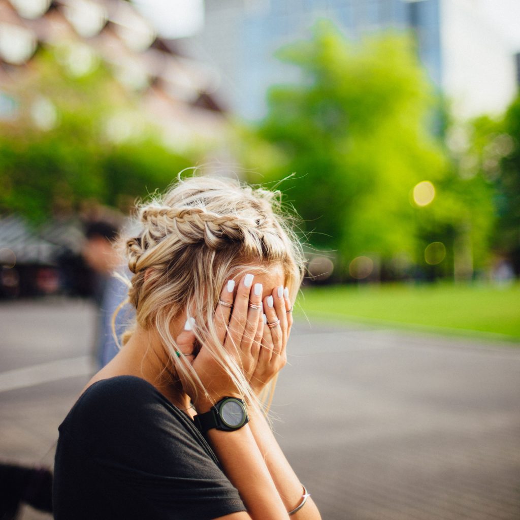 young woman-hands over face-park