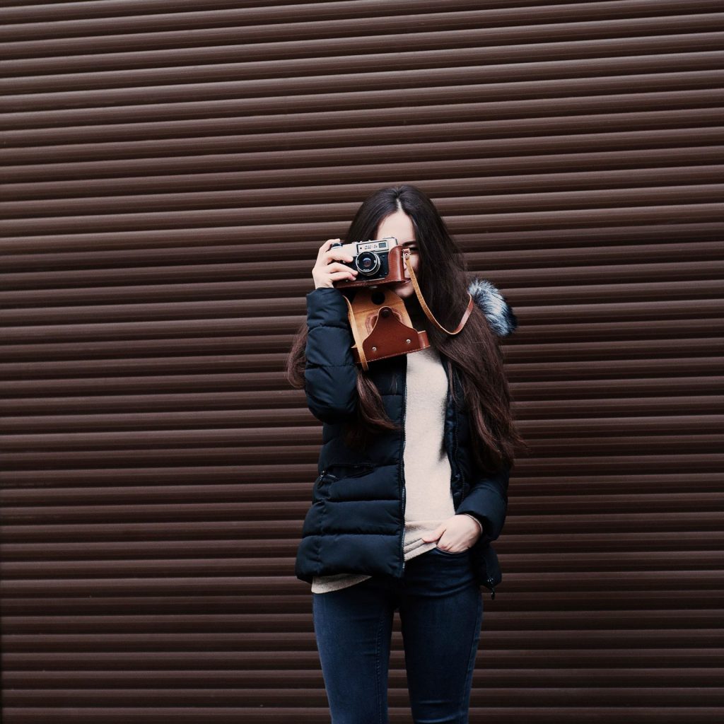 young woman-camera-taking picture